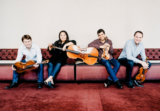 Fyra musiker med instrument. Fotografi.