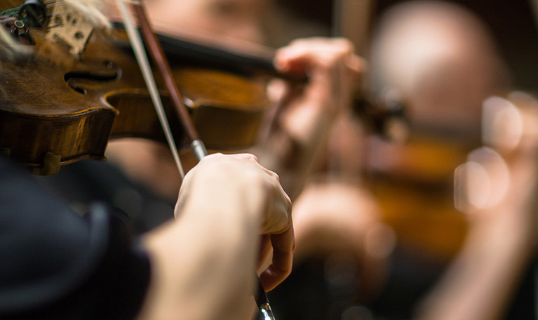 Close up on a violin with a bow