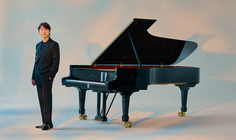 Kvinna som sitter på en stol med en cello. Fotografi